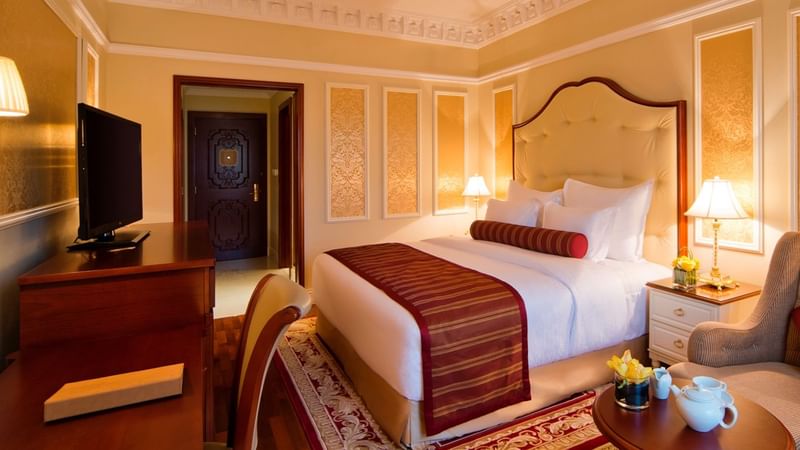 TV & work desk facing king bed in Deluxe Room at Warwick Doha