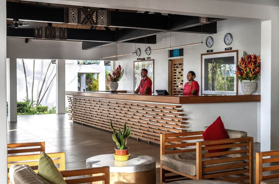 Reception desk with two staff members at Tokatoka Resort - Fiji International Airport.