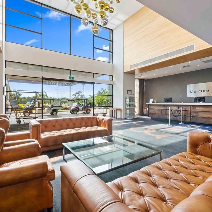 spacious lobby with high ceilings and large windows with natural light at Mercure Kooindah Waters