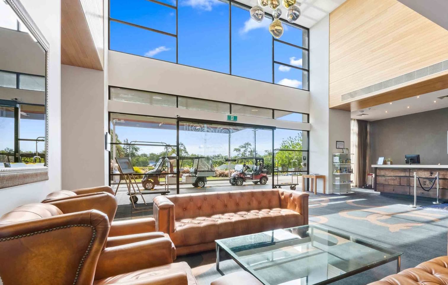 Stunning foyer with large windows and reception area at Mercure Kooindah Waters