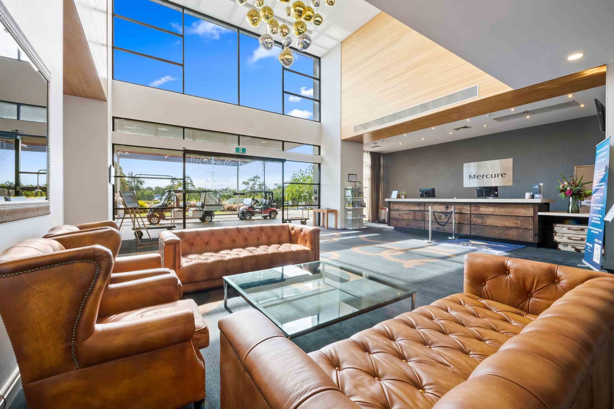 Stunning foyer with large windows and reception area at Mercure Kooindah Waters