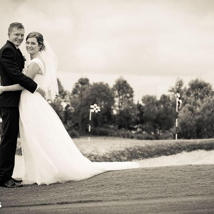 Bride and groom smiling and posing for camera at Mercure Kooindah Waters