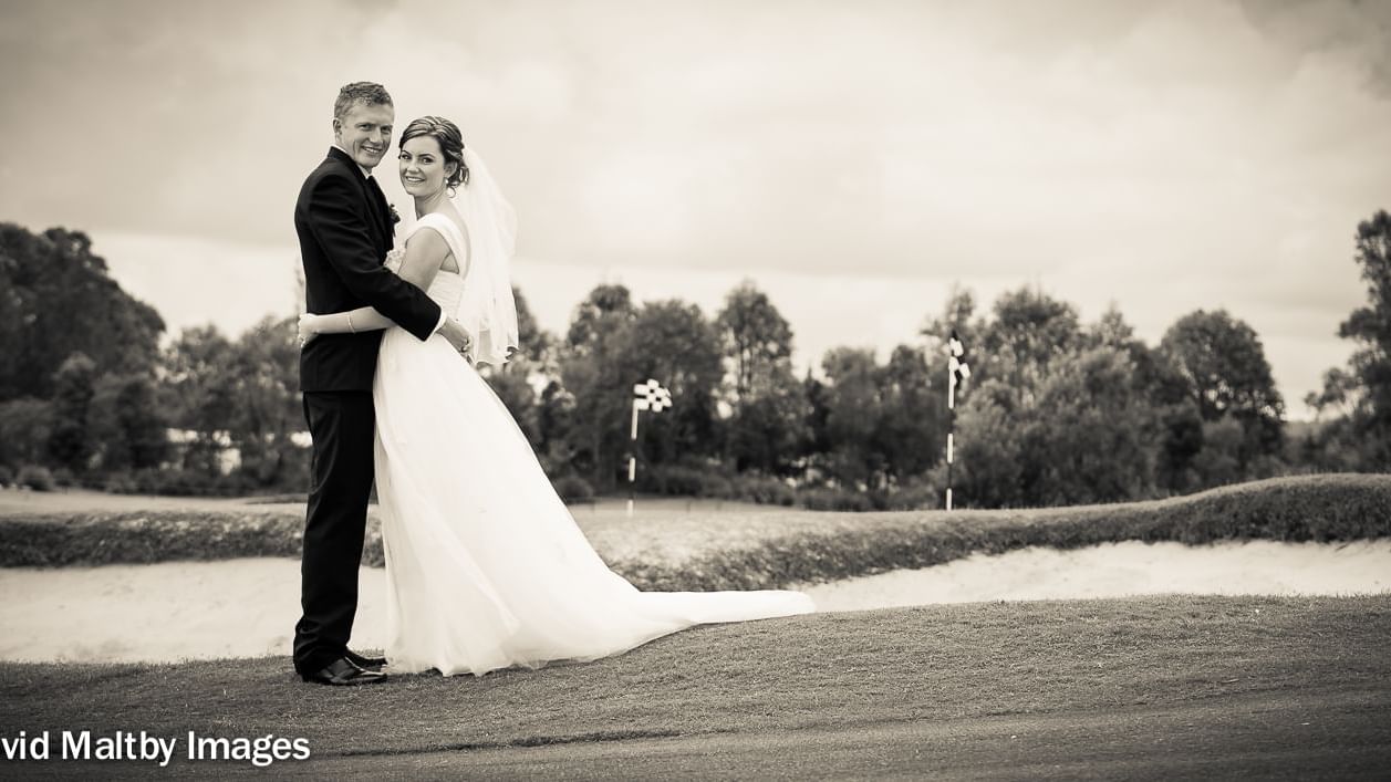 Bride and groom smiling and posing for camera at Mercure Kooindah Waters