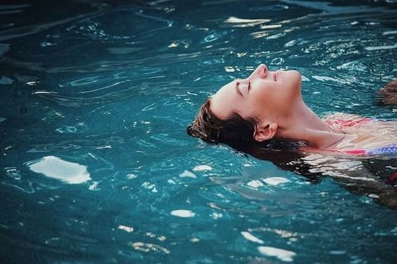 Woman floating in the pool at Temple Gardens Hotel & Spa