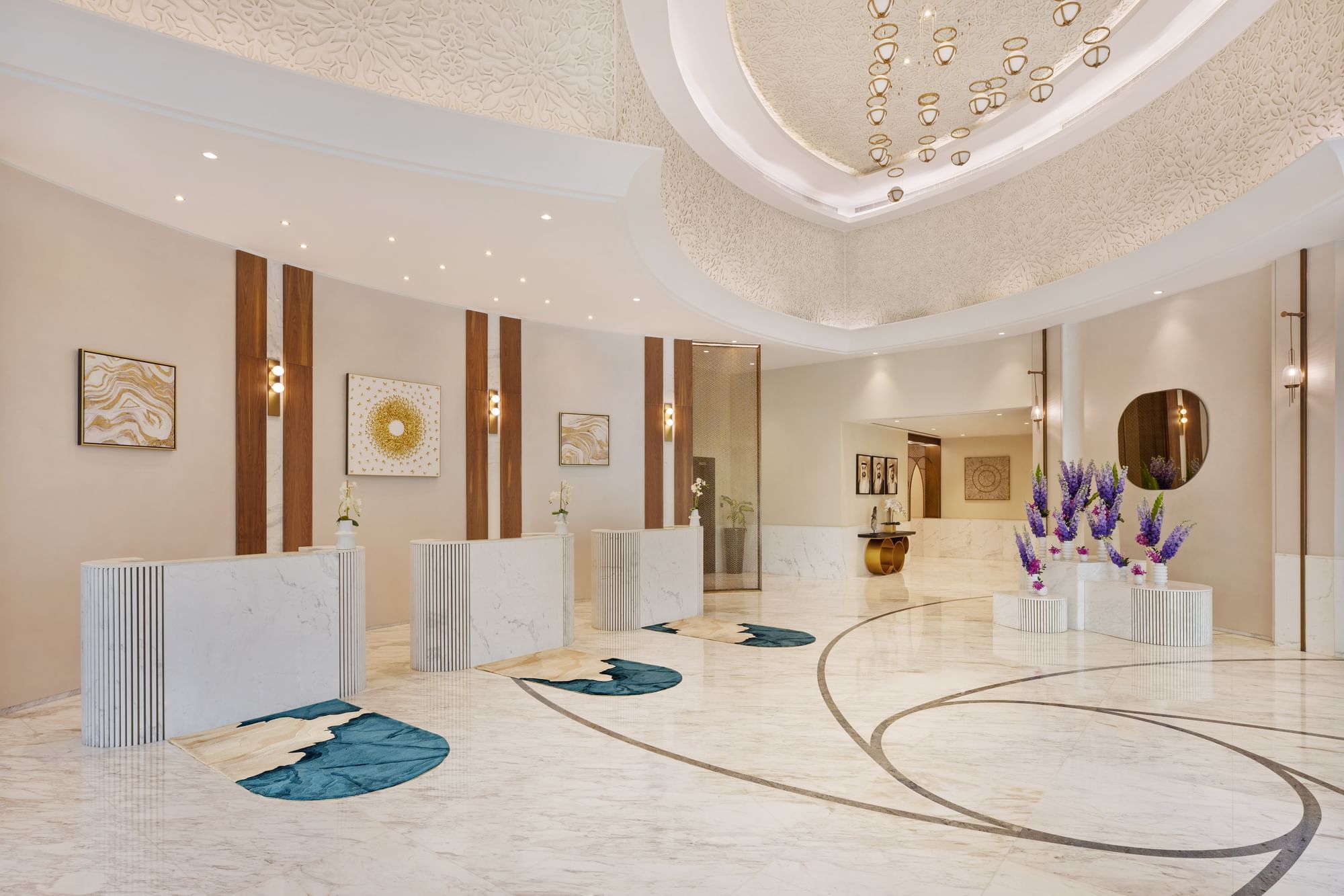 Lobby area with front desks and floral arrangements at DAMAC Maison Royale The Distinction
