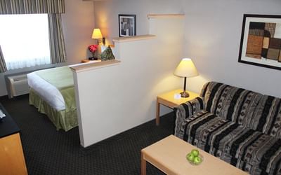 Bedroom with living area in Vantage Room at Fort McMurray Hotels