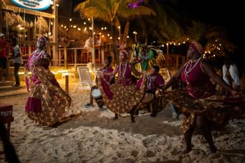 Traditional dancers performing on the beach at night by the restaurant in Paradise Beach Hotel