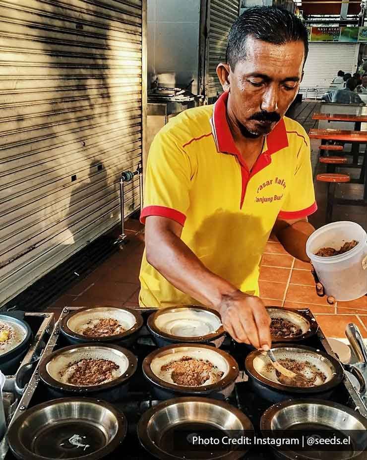 A Hawker was making apam balik at Tanjung Bungah Night Market - Lexis Suites Penang