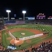 A baseball diamond with the teams lined up in a full ballpark.