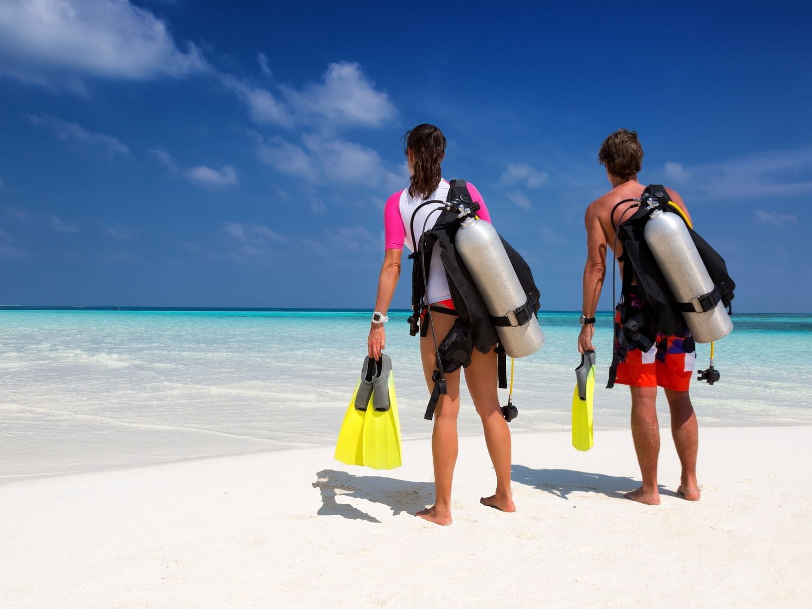 A couple in scuba diving gear on a beach near Southern Palms