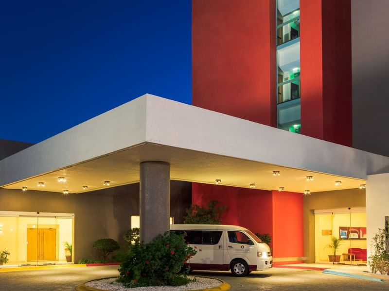A van parked at the entrance of the Fiesta Inn at night