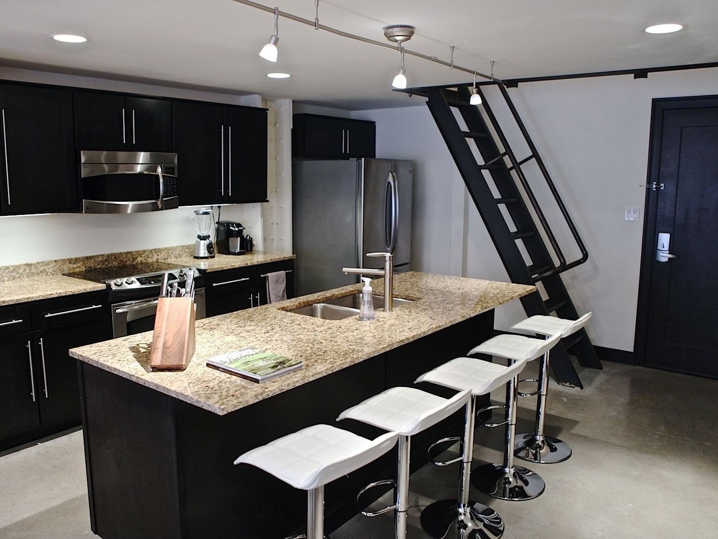 Kitchen with appliances in Unit N Terrace at The Mayo Hotel
