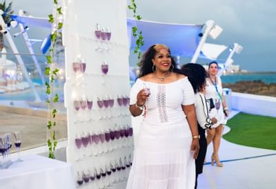 Lady holding a drink in an Event, The Morgan Resort Spa Village