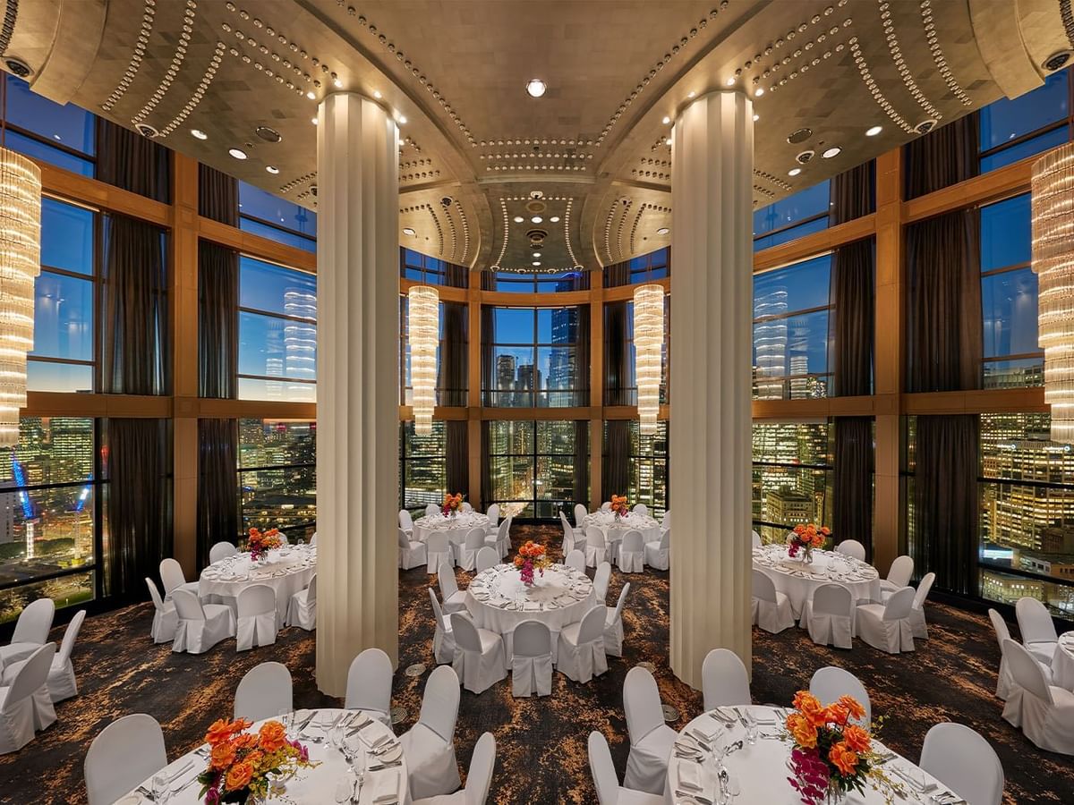 Dining room overlooking a cityscape through windows at Crown Hotels