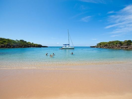 A family by the boat at the sea near Gran Ventana Beach Resort