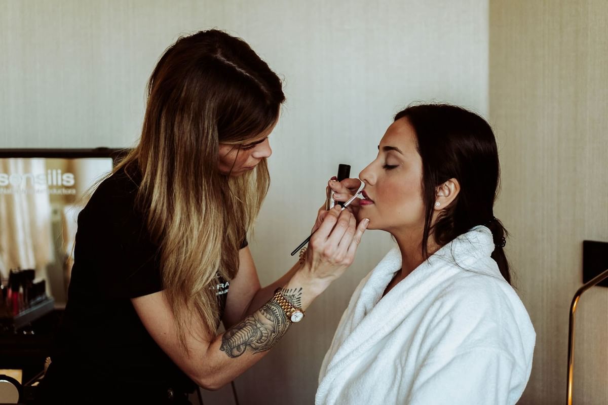 Makeuping a bride  by a makeup artist at Almanac 