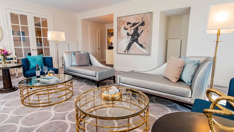 Presidential Suite room features silver furniture, gold glass tables, and a large artwork at Warwick Melrose Dallas