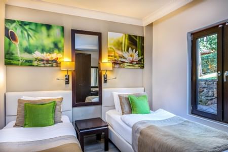 A Suite with two beds and an open window at Marmaris Bay