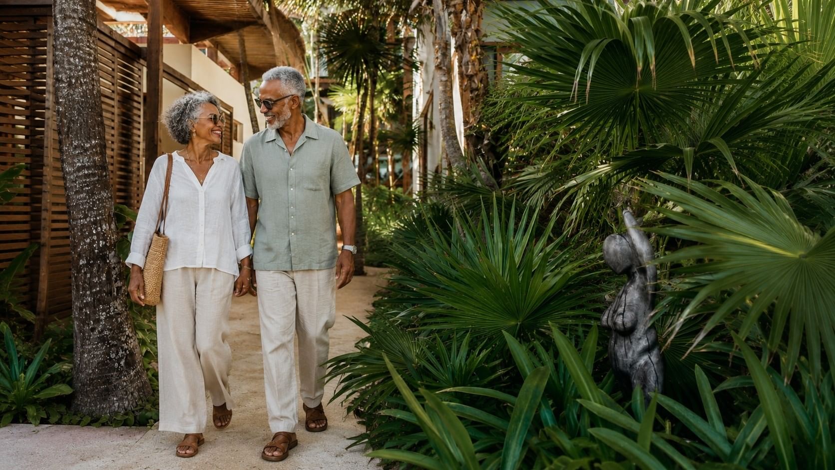 Older couple walking together through the tropical gardens at Mi Amor