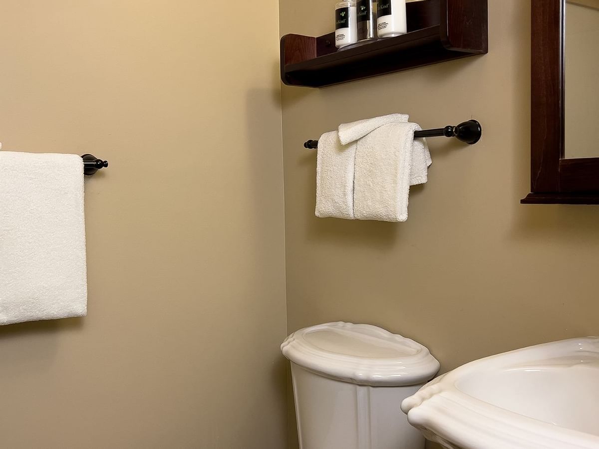 Bathroom with towels, sink, toilet