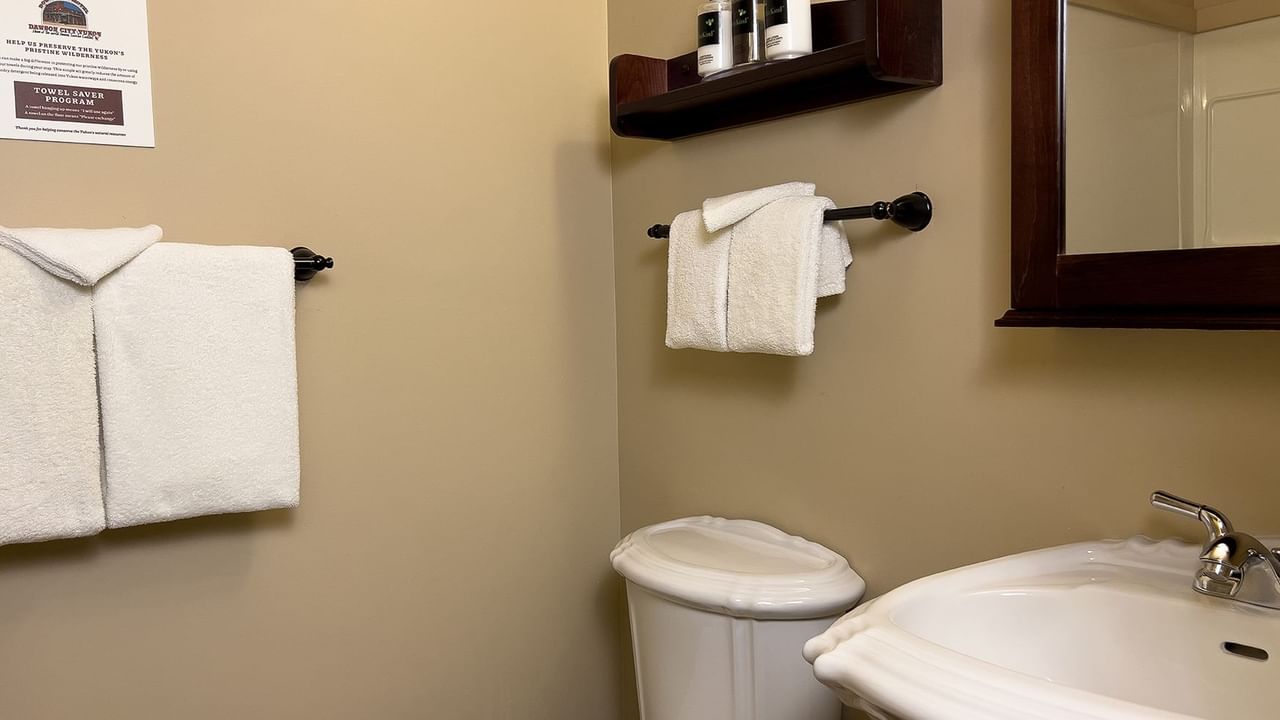 Bathroom with towels, sink, toilet