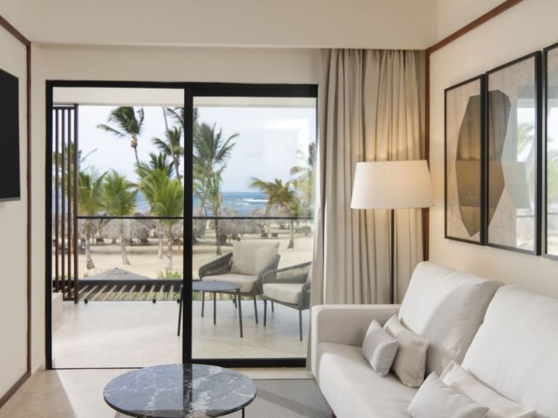 White-themed living area & balcony in Viento Suites at Live Aqua Punta Cana