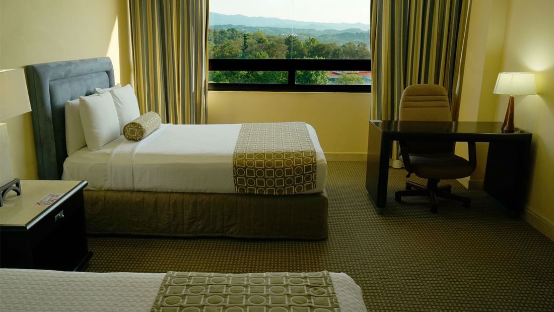 Bedroom with forest view in Junior Suite at Gamma Hotels