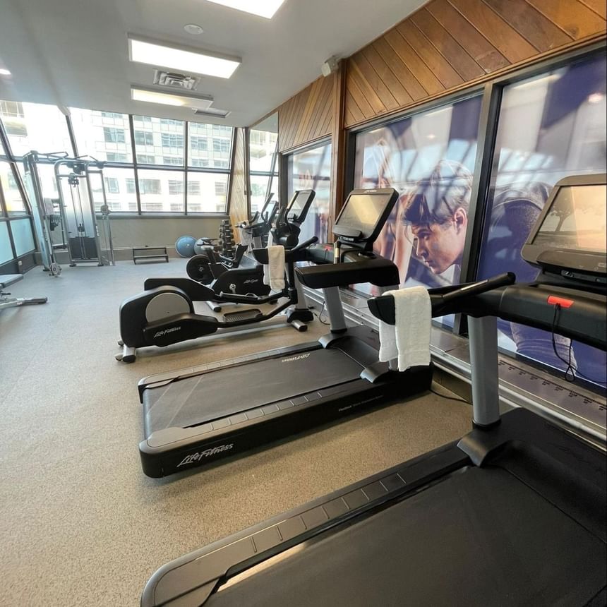 Gym at the Atlantica Hotel Halifax with treadmills and a wall poster of a man.