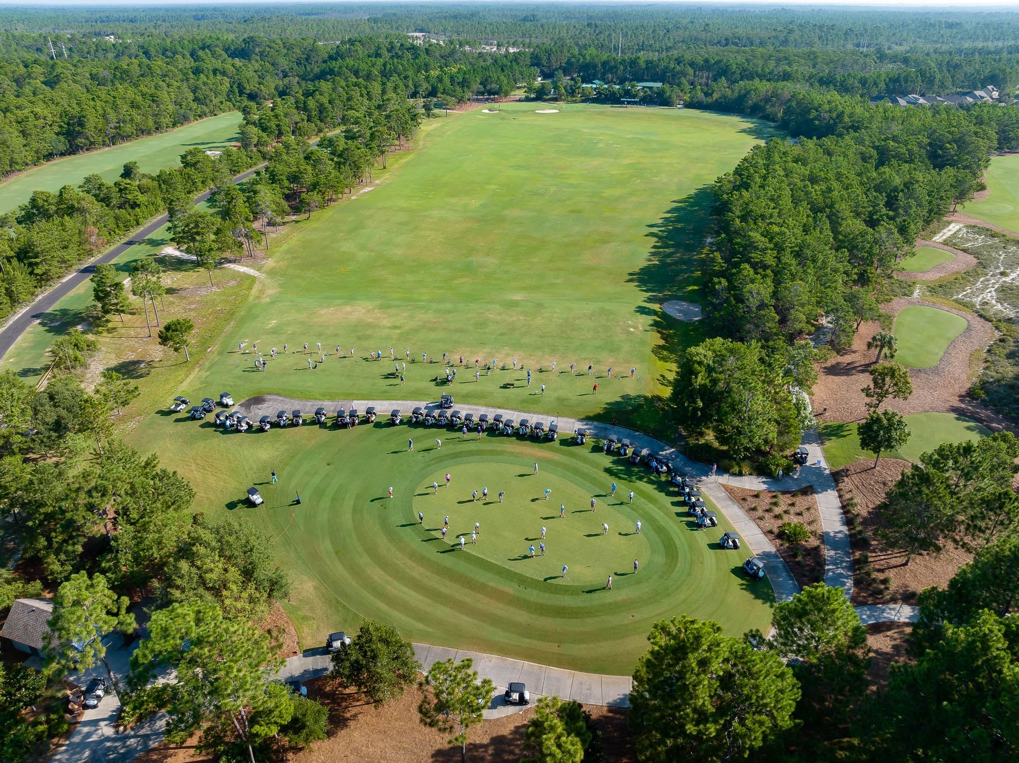 Aerial view of golf course with lush greenery nearby at Camp Creek Inn