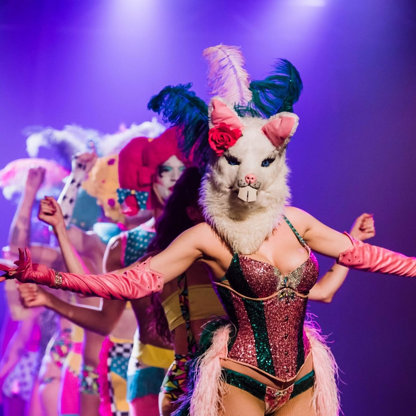 Performers in vibrant costumes and masks at the Adelaide Fringe Festival.