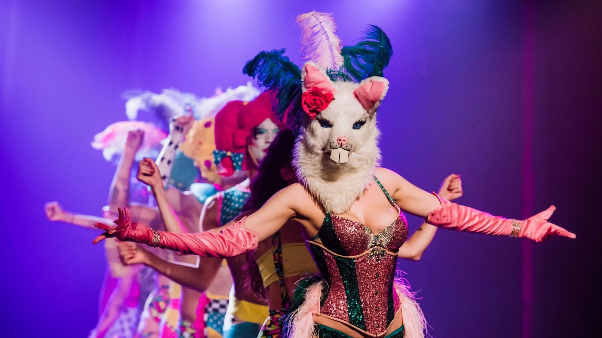 Performers in vibrant costumes and masks at the Adelaide Fringe Festival.