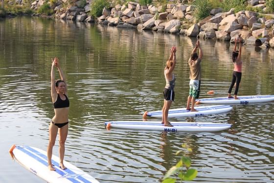 People engage in Stand Up Paddle Boards at Stein Eriksen Lodge