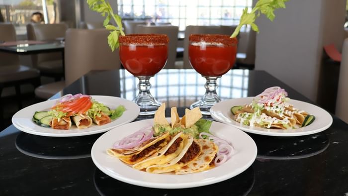 Entrantes mexicanos con tacos, quesadillas y cócteles adornados con apio en Fonda De Hermosillo, Araiza Hermosillo 