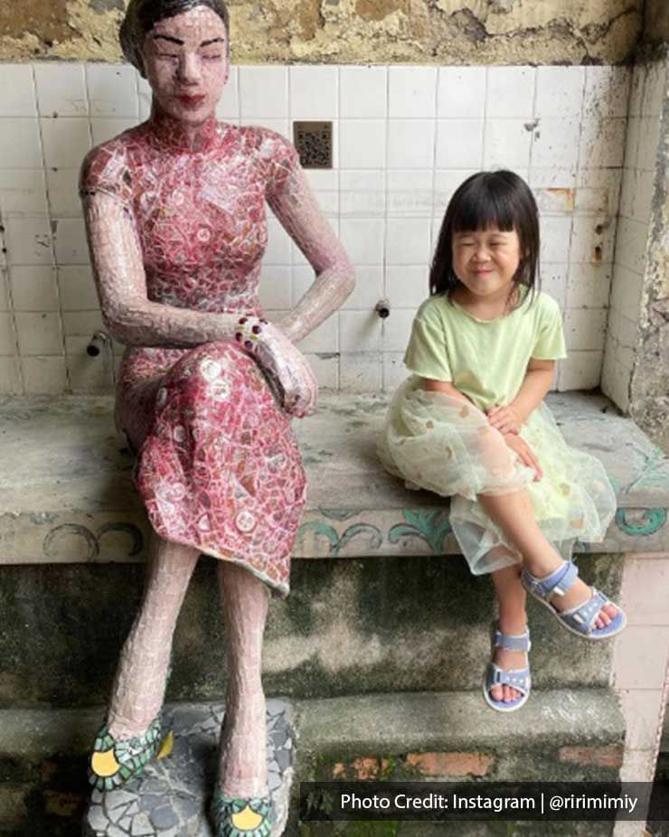 Girl posing by a porcelain statue in Kwai Chai Hong, a local attraction near Imperial Lexis Kuala Lumpur