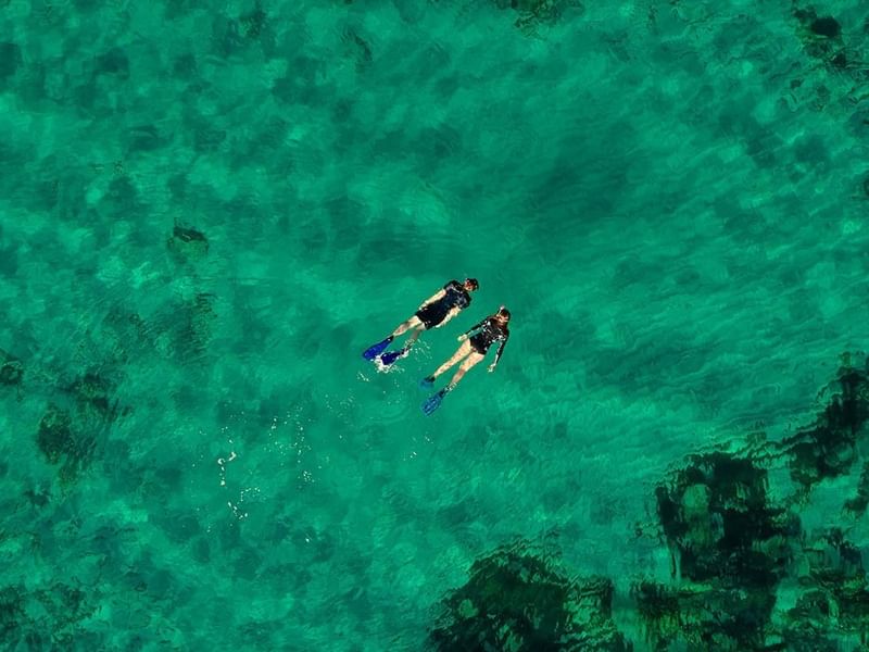 High-angle view of 2 divers swimming near Falkensteiner Hotels