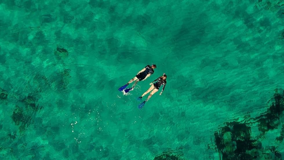 High-angle view of 2 divers swimming near Falkensteiner Hotels