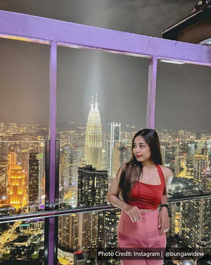 Lady posing on the Sky Deck of Menara Kuala Lumpur Tower, a modern attraction near Imperial Lexis Kuala Lumpur