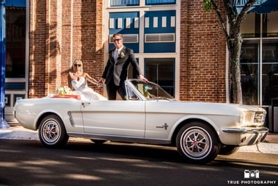 Bride and groom in vintage mustang at Horton Grand Hotel