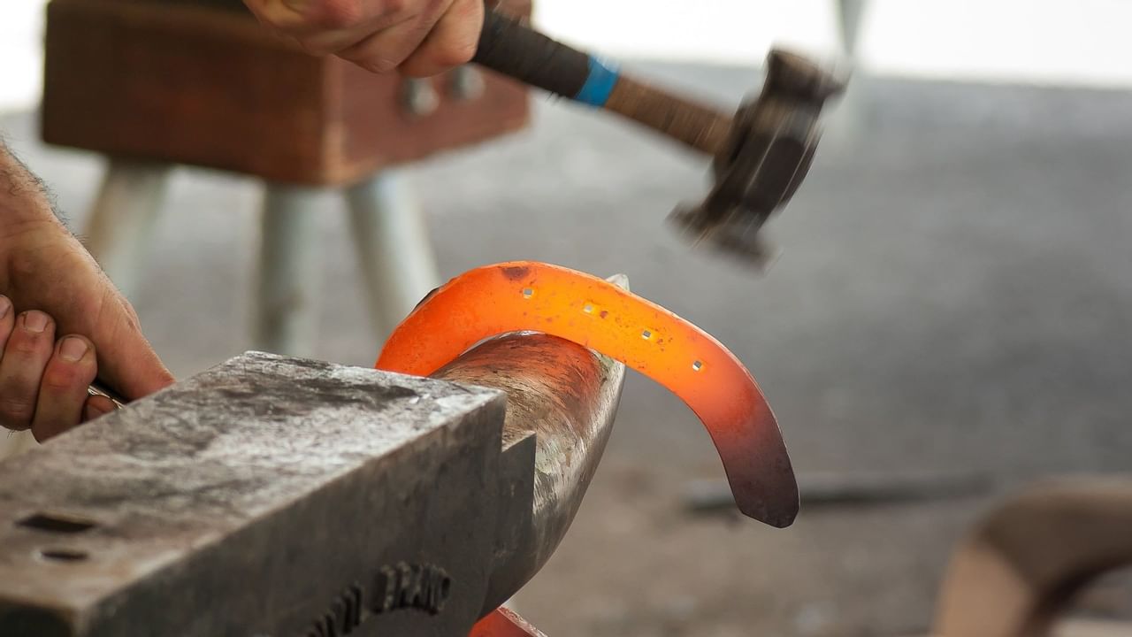 Man using hammer on metal