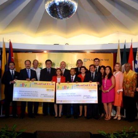 Group posing at cheque presentation at Federal Hotels
