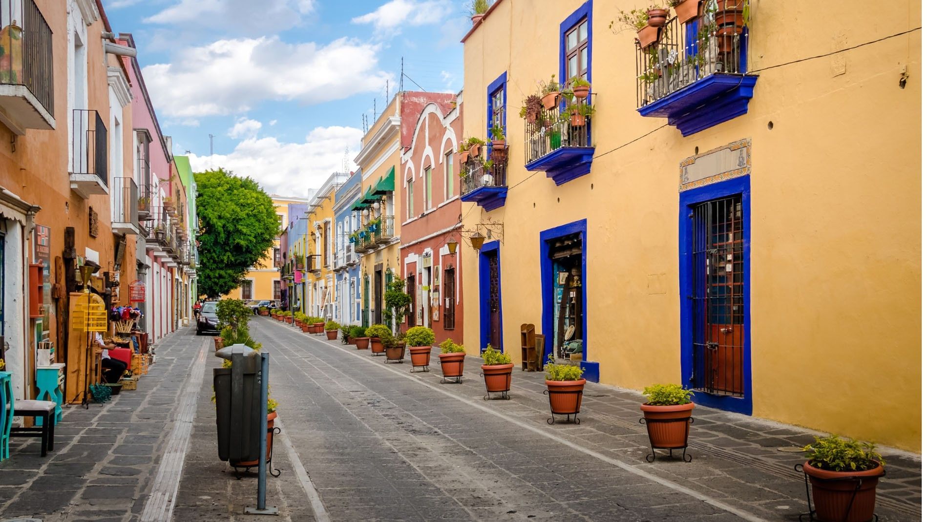 Charming Centro Histórico de Puebla featuring vibrant yellow and blue buildings near Camino Real Puebla Angelopolis