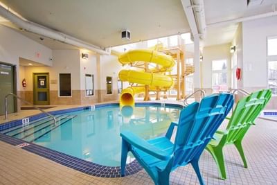 Waterslide & loungers by the pool deck in Waterpark at Service Plus Inns & Suites Drayton Valley