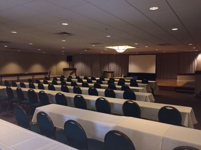 Tables arranged for a meeting in the hall at UMass Lowell Inn