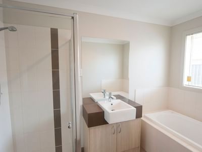 Clean bathroom with shower, sink, and bathtub at La Trobe University Regional Housing – Shepparton.