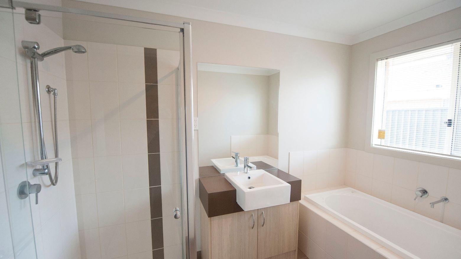 Clean bathroom with shower, sink, and bathtub at La Trobe University Regional Housing – Shepparton.
