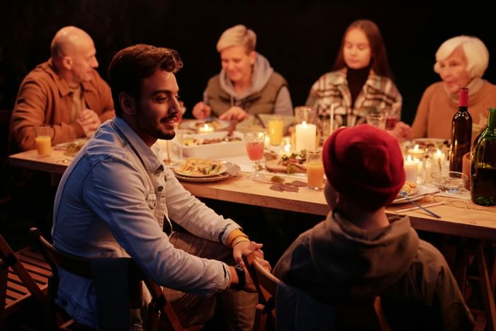 Family dining together in a Restaurant at Anaheim Portofino Inn, a budget-friendly suite near Disneyland for large families