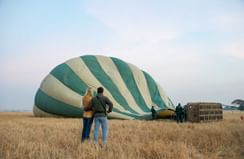 A couple near the air Baloon at Kirawira Serena Camp