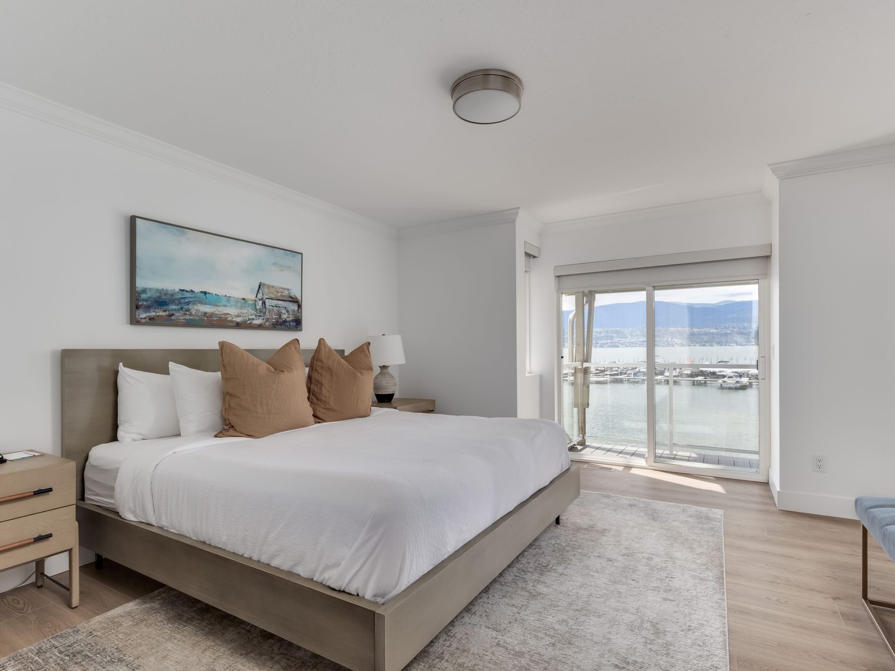 Cozy bed with wooden floors in Three Bedroom Luxury Lakeside Villa at Manteo Resort Waterfront