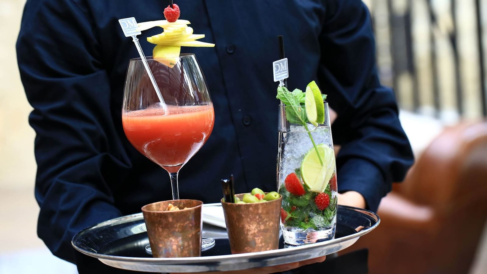 Waiter serving cocktails in The Bar at Domaine de Manville