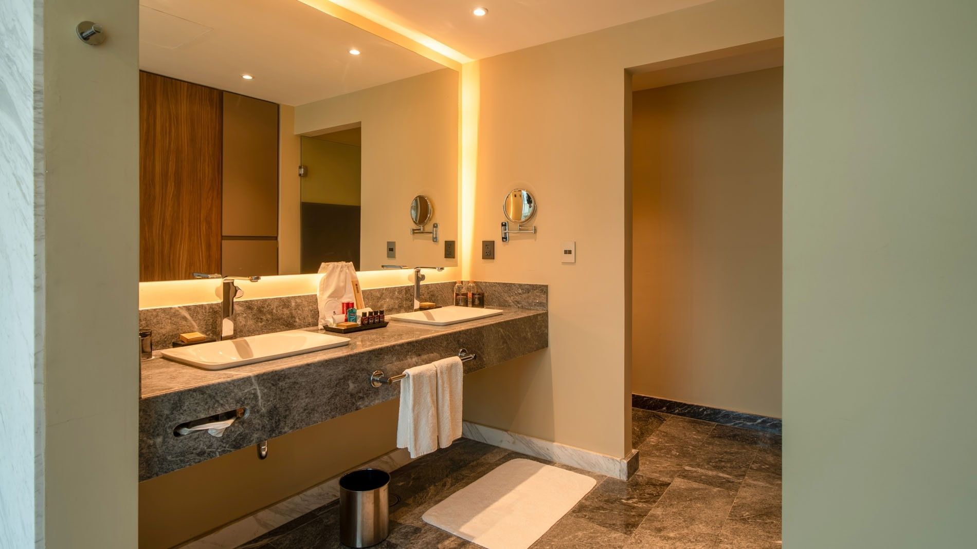 King Master Suite with double marble sinks, large mirror, and warm lighting at Camino Real Fashion Drive, Monterrey